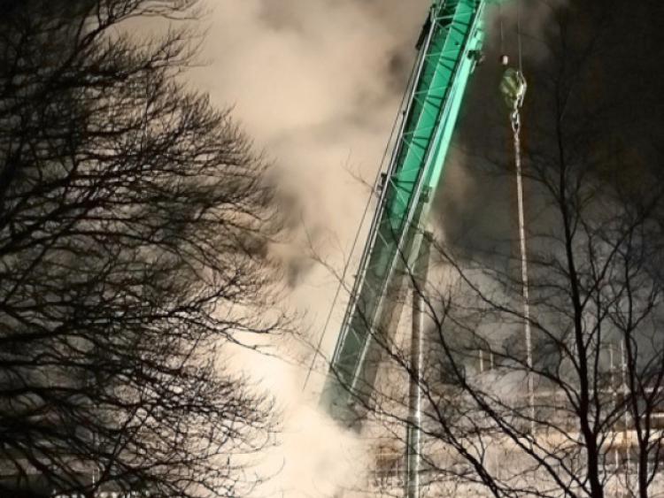 Smoke engulfs the Quinn Group crane at the Ballinamore School site last night. Gardai believe the fire was maliciously lit.
