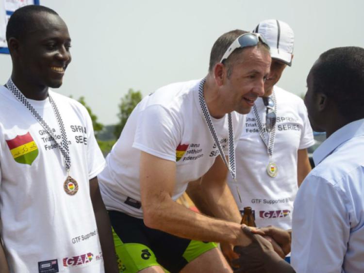 Lough Key Tri Clubs Andy Brennan being presented with his prize for overall winner at the first ever Triathlon to be held in Ghana last Sunday.