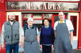 Oliver McCabe and his wife Mary are pictured with their sons Brian and Colin outside their butcher shop in Keadue which closed on Saturday, February 3rd, after 89 years.