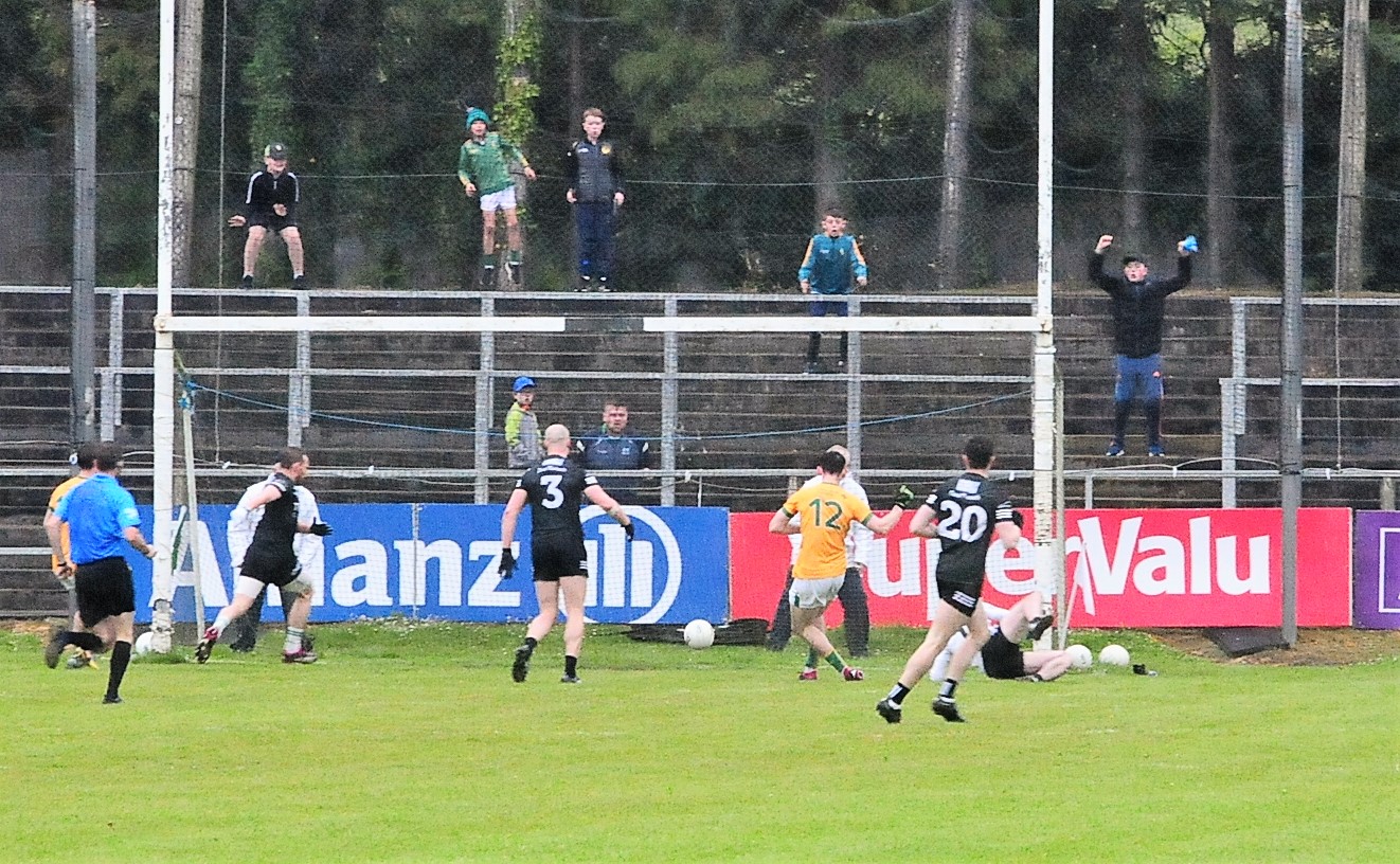 Mark Plunkett scores Leitrim's second goal to the joy of the supporters behind the goal Picture: Willie Donnellan