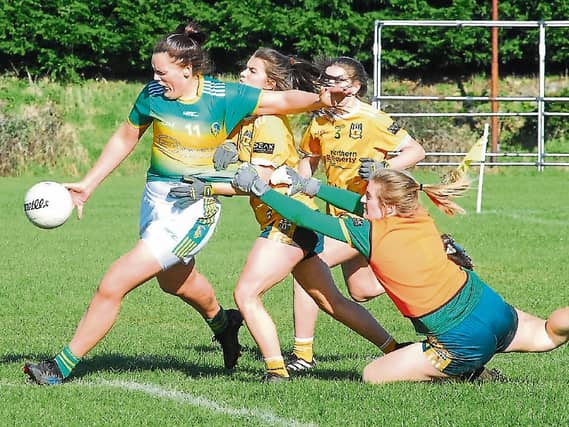 Michelle Guckian is restrained as she shoots on goal against Antrim Picture: Willie Donnellan
