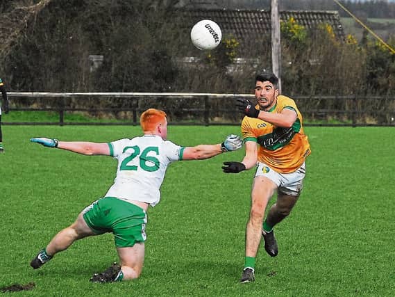 Emlyn Mulligan handpasses the ball over London's Matthew Walsh last Sunday Picture: Willie Donnellan