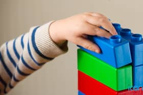 Children were introduced to a new sorting game using blocks, where half were taught to sort the blocks by shape and half by colour.