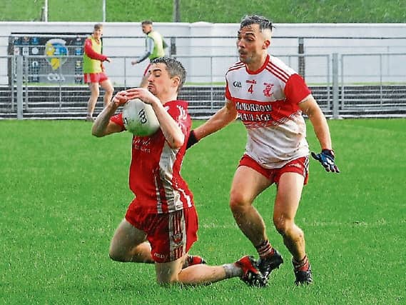 Gary Fowley gathers the ball under pressure from James McDowell Picture: Willie Donnellan