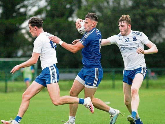 Melvin Gaels Cillian McGloin attempts to evade the challenge of St Mary's Mark Diffley and Gavin Reynolds last Saturday in Kinlough Picture; James Molloy