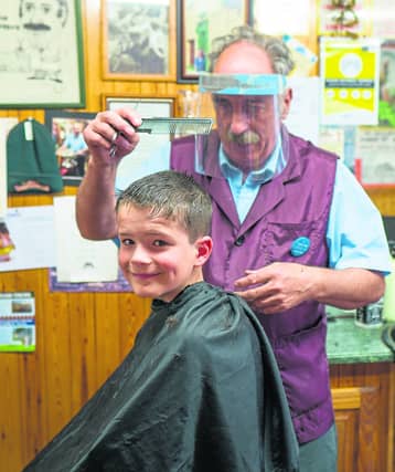 Noah Bosquette from Carrick-on-Shannon was a happy boy getting his first haircut in a while from barber Michael Masterson in last Monday
