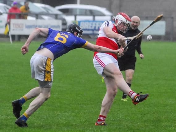 Cluainin's Declan Ryan blocks a shot from Carrick's Stephen Goldrick. Photo by Willie Donnellan