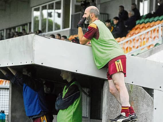 Annaduff's Nigel Cox goes some lengths to ensuring he has the best seat in the house at the Smith Monumentals Intermediate C/ship Quarter-Finals. Photo by Willie Donnellan