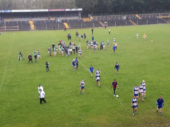 Mohill celebrate after the final whistle as despondent St. Mary's players leave the field