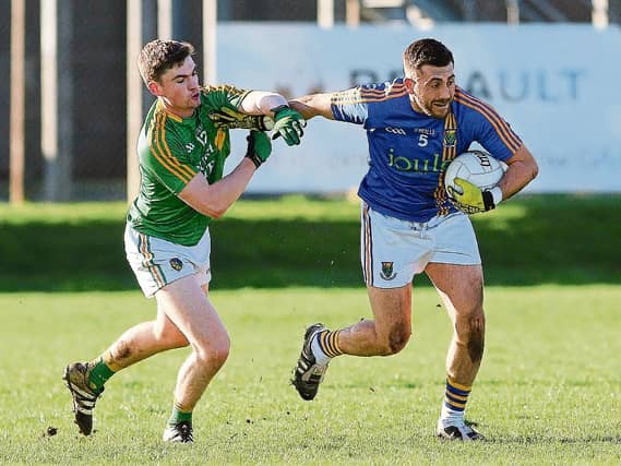 Leitrim's Ryan O'Rourke is held off by Wicklow's Darren Hayden during last Sunday's Allianz League Division 4 clash in Joule Park Aughrim. Photo by Garry O'Neill
