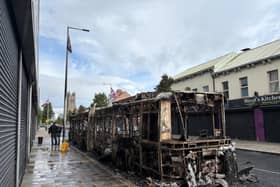 A burned-out Glider bus on Newtownards Road in east Belfast after anti-immigration violence