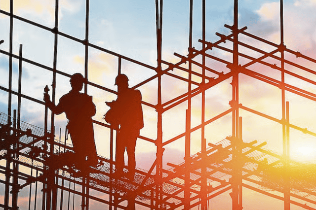 Two people working on a construction site