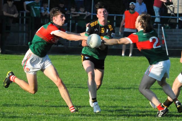 Aughnasheelin's Ciaran Cullen breaks through the challenge of Kiltubrid's Iarlaith O'Brien and Marc Gannon Picture: Willie Donnellan