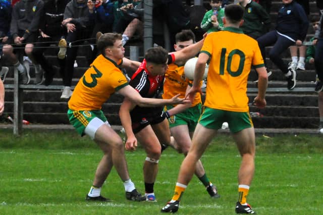 Fenagh St Caillin's Oisin McLoughlin is tackled by Ballinamore Sean O'Heslins' Michael McKiernan Picture: Willie Donnellan