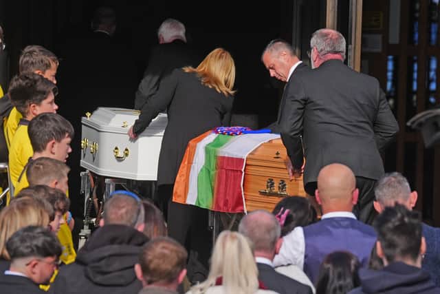 The coffins are brought into the parish centre in Waterford (Brian Lawless/PA)
