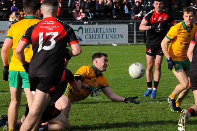 Dean McGovern gets the ball away to a Ballinamore teammate against Fenagh on Sunday Picture: Willie Donnellan
