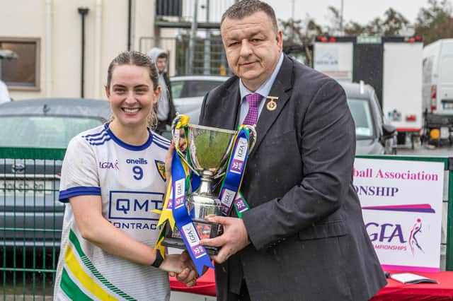 St Brigid's captain Niamh Donegan is presented with the Cup by Connacht LGFA President Keith Gilroy Picture: Stefan Hoare