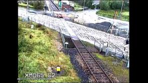 VIDEO: Gardaí investigating after red van crashes through level crossing barrier 