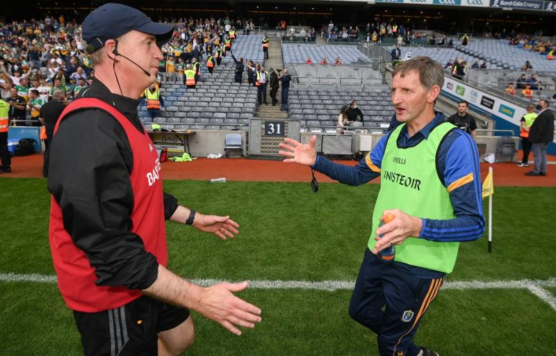 Roscommon manager Liam Tully congratulates Declan Kelly after Offaly's win.