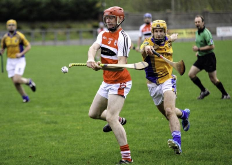 Liam Moreton avoids a Calry hook as he delivers a pass last Monday in Ballinamore.