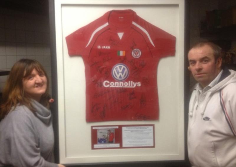 Gerladine and Declan Gill, parents of James who passed away last year are pictured with the signed and framed Sligo Rovers jersey.