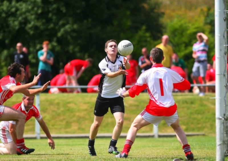 A Glenfarne/Kilty player fists the ball over the bar last Sunday in Drumshanbo. Photo by James Molloy