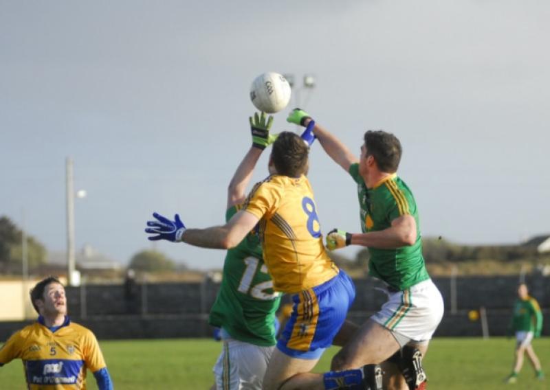Donal Wrynn fists the ball clear ahead of Clare's Gary Brennan and Fergal Clancy last Sunday in Milltown Malbay. Photo by Willie Donnellan