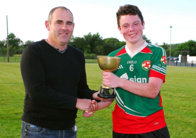 Terence Boyle, Coiste na nOg presents the U-16 league trophy to Kiltubrid captain Owen Dolan after last Wednesday's final.