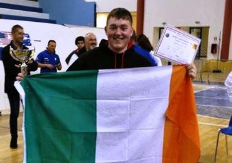 Carrigallen's Conor Hession flies the Irish flag after his victory in the WDFPF World Powerlifting Championships in Sicily last weekend.