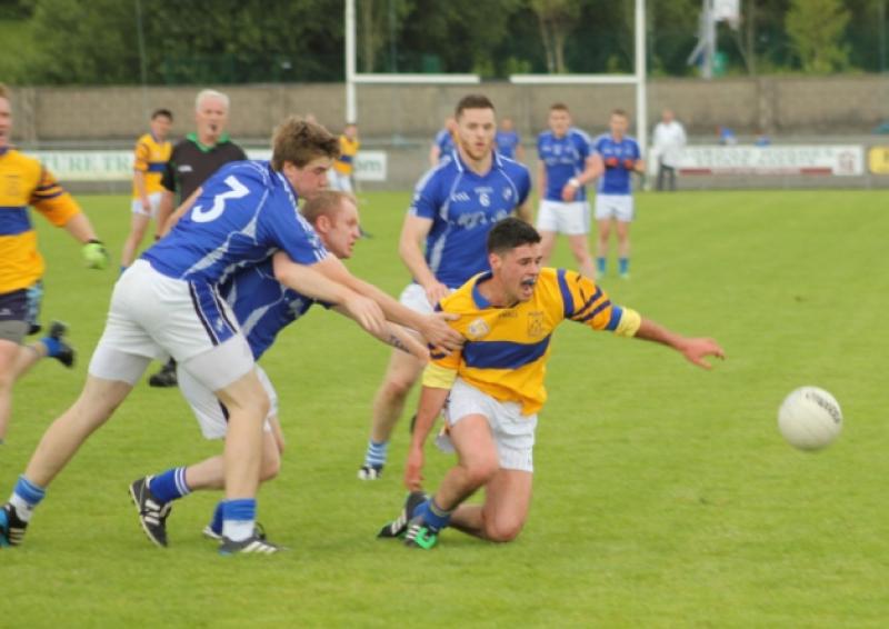 Ciaran Gilheany feels the pressure from Carrigallen's Barry Nash and Andrew McManus.
