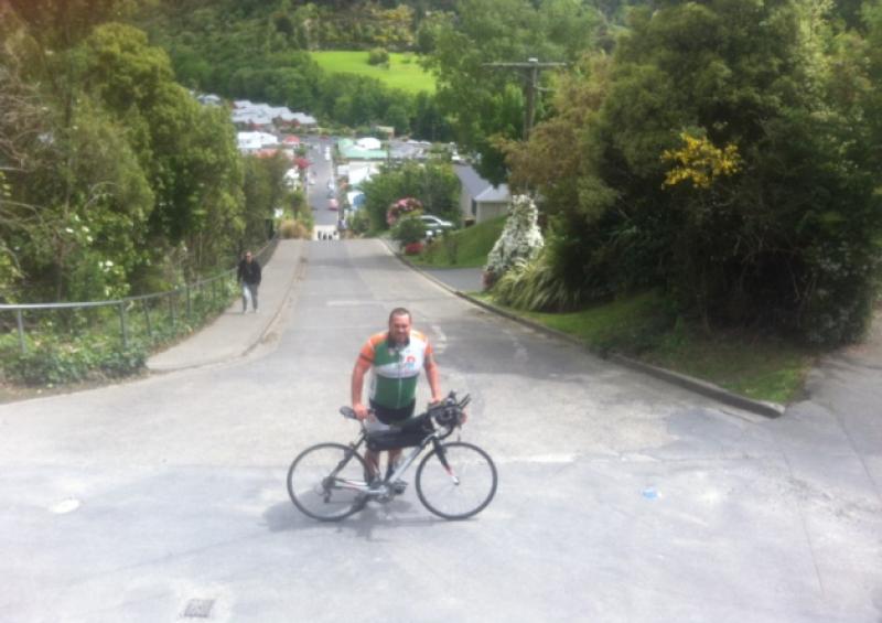 Breifne Earley poses at the top of the World's steepest street in New Zealand.