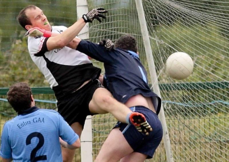 A flying Fergal Clancy fists the ball past Eslin keeper Enda Turbitt for a goal for Glenfarne/Kiltyclogher last Sunday.