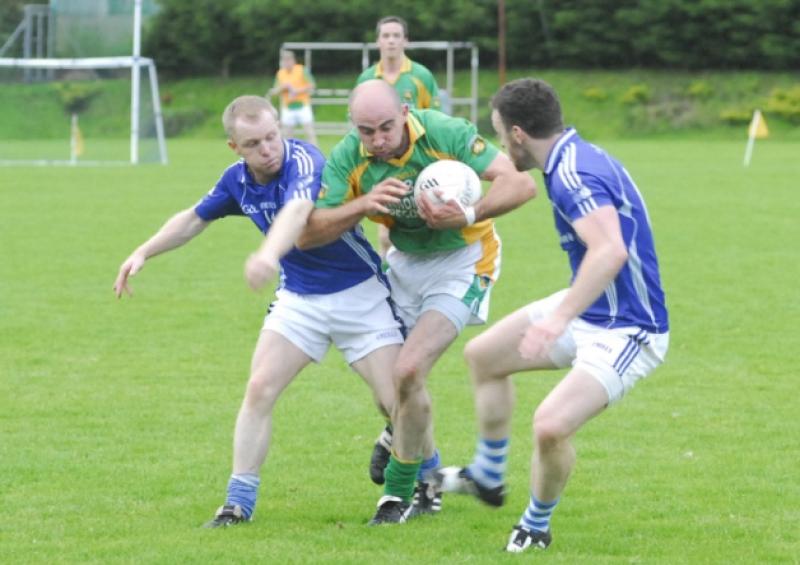 Declan Maxwell breaks through the challenge of Carrigallen's Andrew McManus and Gary Reynolds in last Saturday's Connacht Gold Senior Championship eighth place playoff.